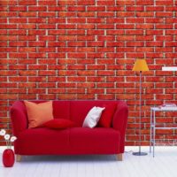 Red sofa on brickwork background