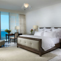Stylish bed in the bedroom by the sea