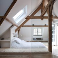White bedroom in the attic of a German house