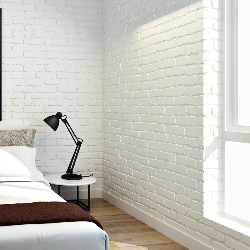 Black table lamp on the bedside table in the bedroom with brick wallpaper