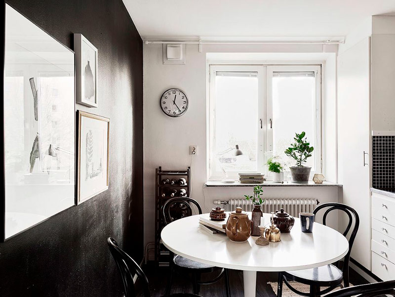 Meja makan putih berhampiran dinding hitam