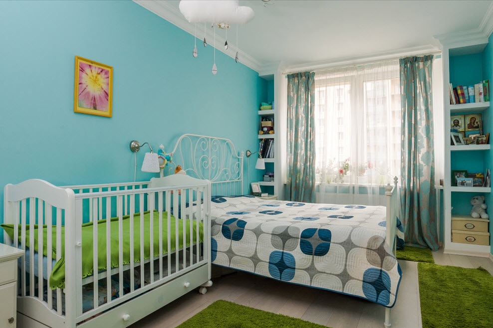 Postýlka pro novorozence v místnosti s modrými stěnami