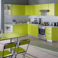Kampinė virtuvė su žaliais fasadais