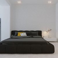 Černá postel na šedém koberci