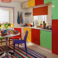 Svītrains paklājs virtuvē ar krāsainām fasādēm.