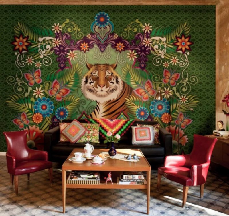 Kilimas su tigru ant gyvenamojo kambario sienos kičo stiliaus.