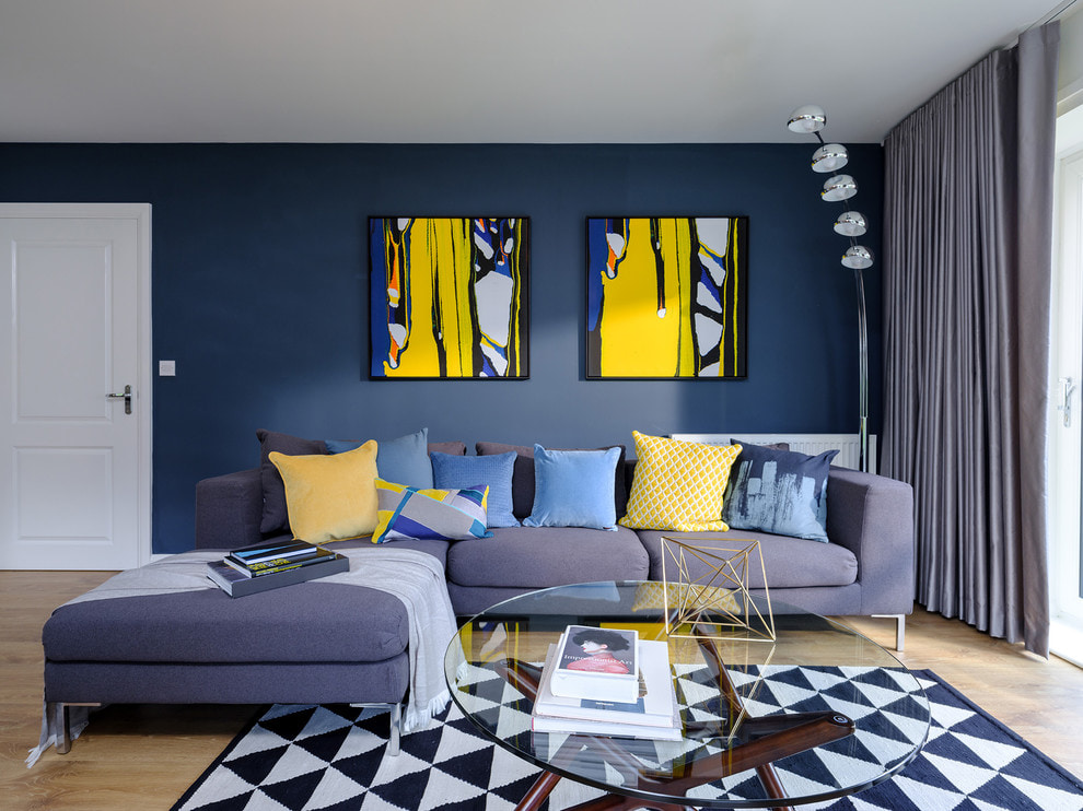 Dva modulární obrazy na modré stěně obývacího pokoje