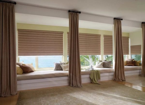 A low, elongated window can be balanced by a ceiling cornice that does not protrude beyond the window opening, in combination with heavy plain curtains on decorative rings.